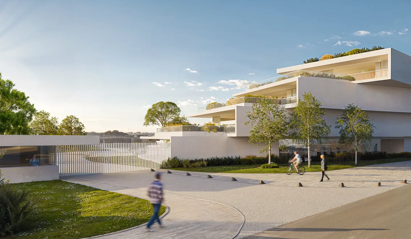 The white terraced buildings of O'RIZON LIVING, seen from the entrance plaza