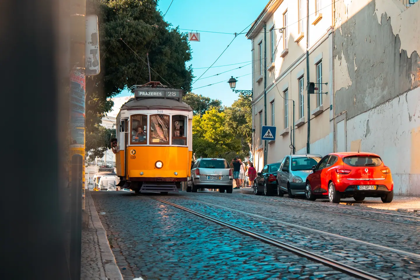 A yellow tram on a cobbled street in Portugal