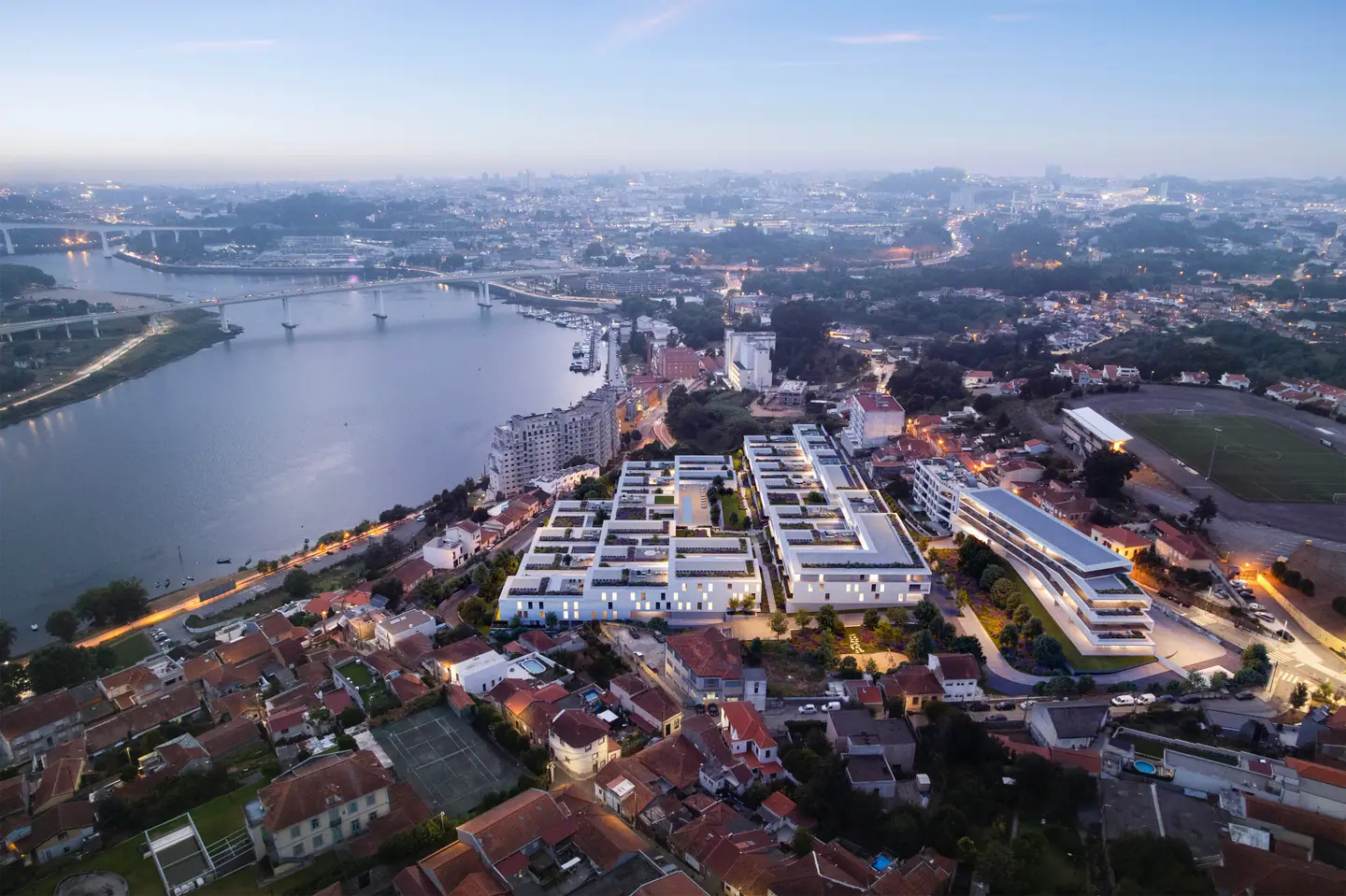 Aerial view at dusk: the complex lit up beside the Douro and its bridges